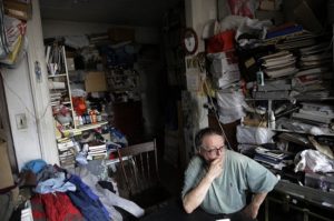 Man sitting in a cluttered room